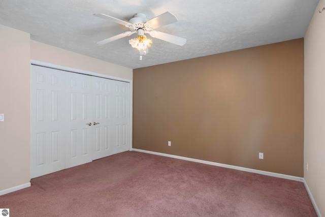 unfurnished bedroom with ceiling fan, a closet, carpet floors, and a textured ceiling