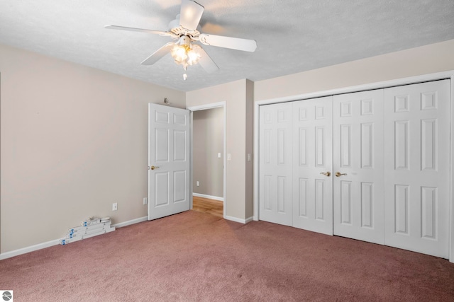 unfurnished bedroom featuring carpet, ceiling fan, a textured ceiling, and a closet