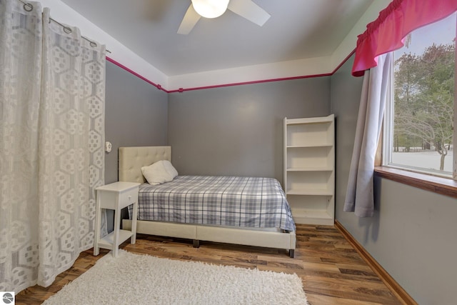 bedroom with ceiling fan and wood-type flooring