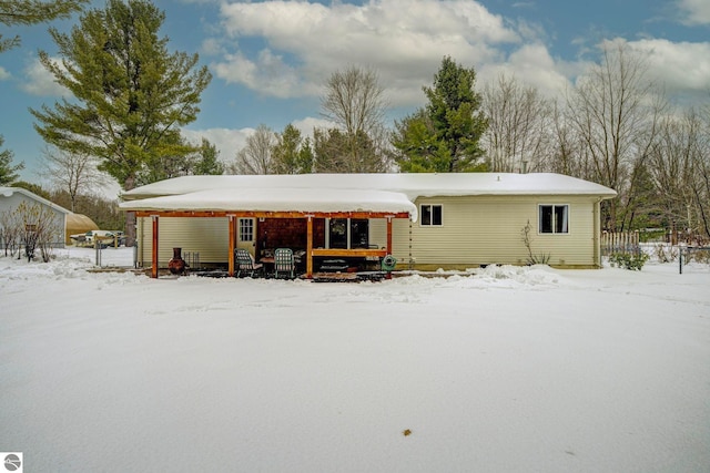 view of snow covered rear of property