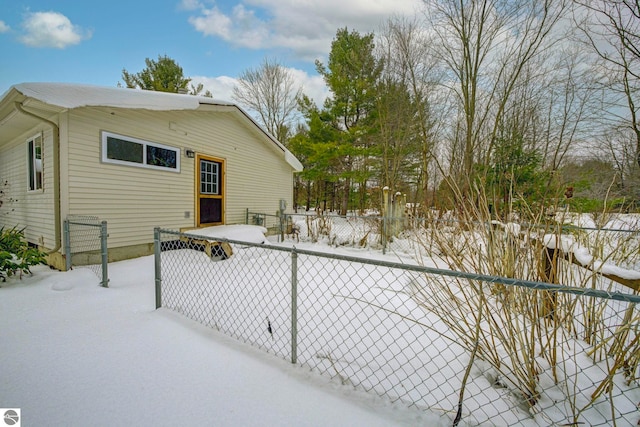 view of snow covered rear of property