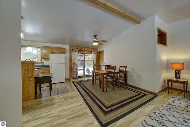 dining area with vaulted ceiling with beams, ceiling fan, and light hardwood / wood-style flooring