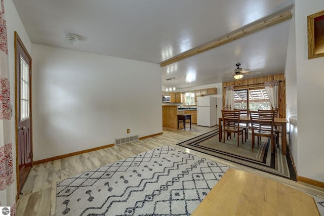 dining space featuring ceiling fan and light hardwood / wood-style flooring