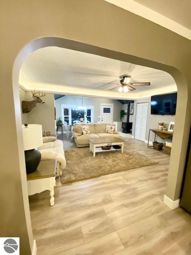 living room with ceiling fan and light hardwood / wood-style floors