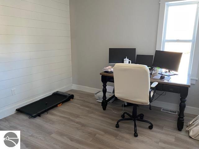 home office with hardwood / wood-style floors