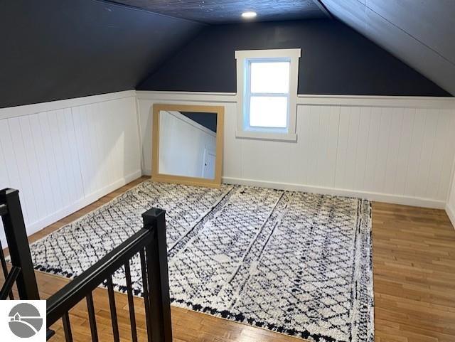 bonus room with hardwood / wood-style flooring and lofted ceiling