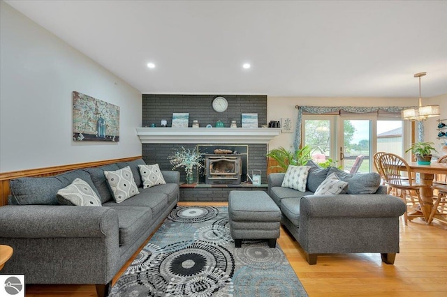 living room featuring a chandelier and light wood-type flooring