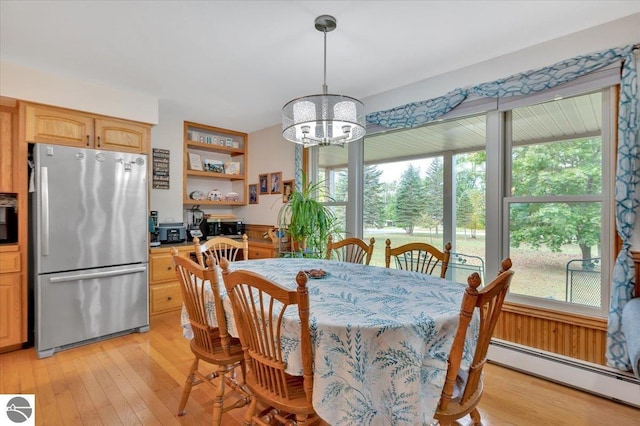 dining room with a baseboard radiator, plenty of natural light, a chandelier, and light wood-type flooring