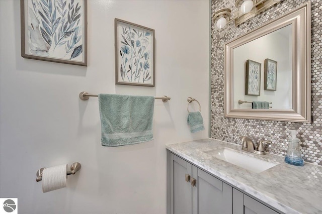 bathroom featuring tasteful backsplash and vanity