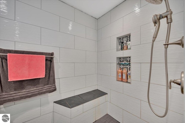 bathroom with tiled shower