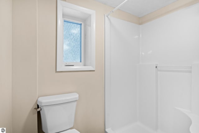 bathroom with toilet and walk in shower