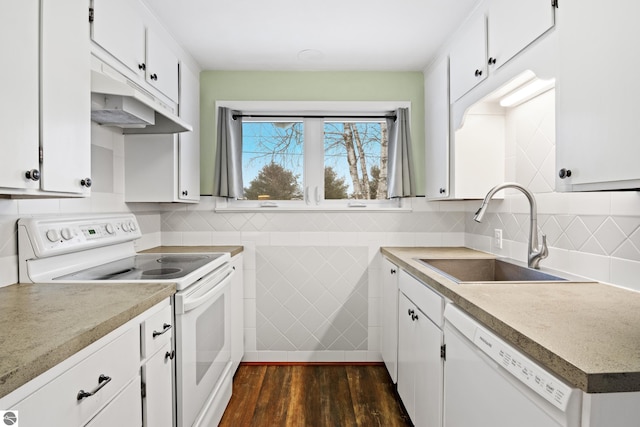 kitchen with white appliances, white cabinets, a sink, and dark wood-style flooring