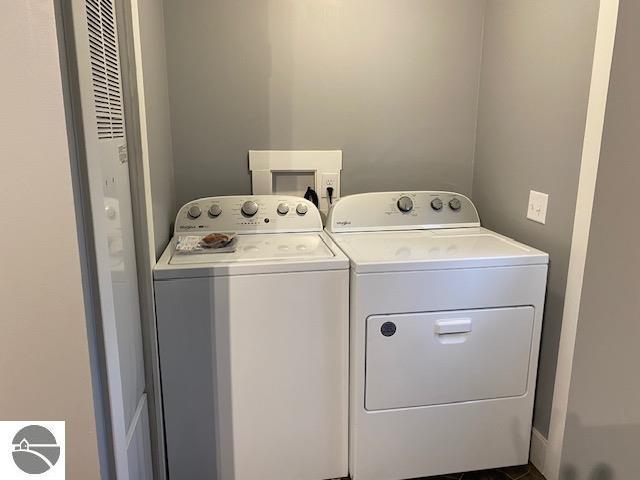 washroom with washing machine and clothes dryer