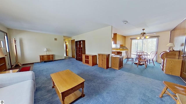 living room with dark colored carpet and ceiling fan