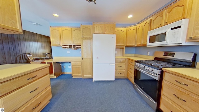 kitchen with dark colored carpet, light brown cabinets, built in desk, and white appliances