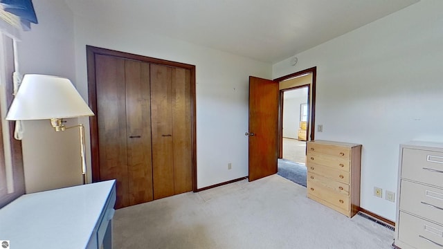 bedroom with light colored carpet and a closet