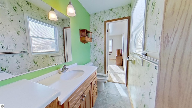 bathroom featuring tile patterned flooring, vanity, and toilet