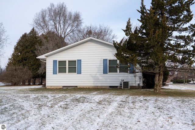 view of snowy exterior with central air condition unit