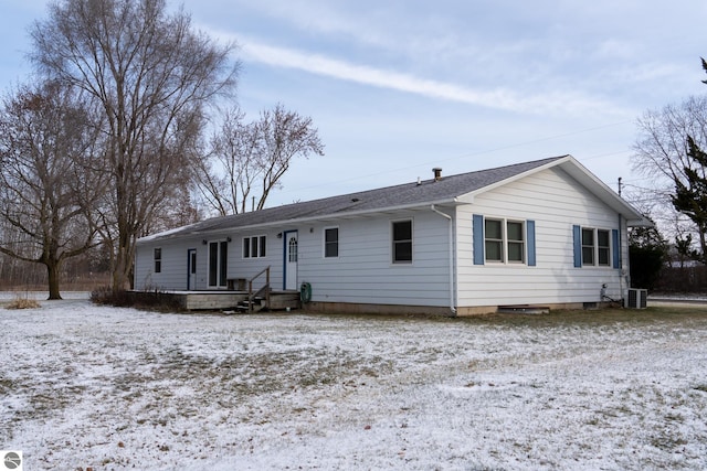 view of snow covered back of property