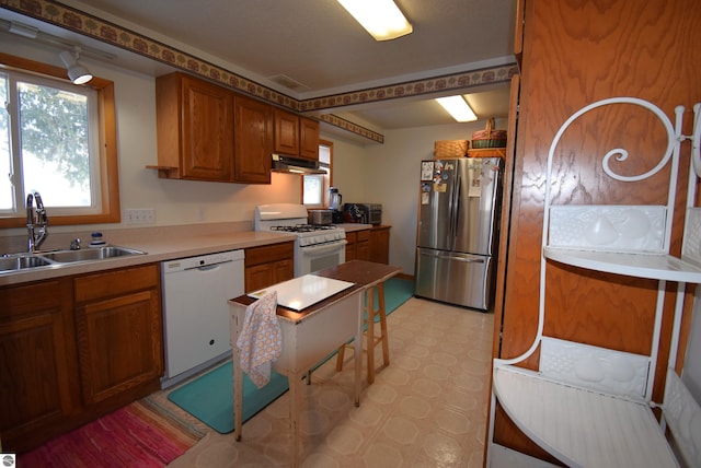 kitchen featuring white appliances and sink