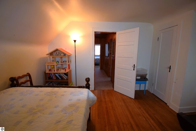 bedroom featuring wood-type flooring and lofted ceiling