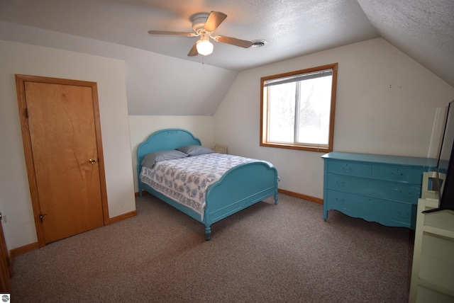 bedroom with carpet, a textured ceiling, vaulted ceiling, and ceiling fan