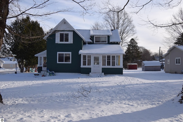 view of snow covered back of property