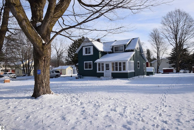 view of snow covered back of property