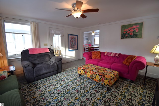 carpeted living room featuring ceiling fan and plenty of natural light