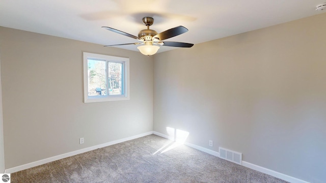 unfurnished room with ceiling fan and carpet floors