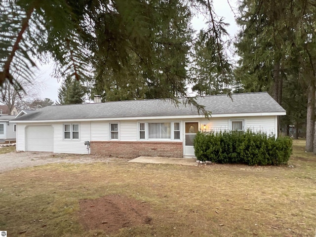 ranch-style home with a front yard and a garage