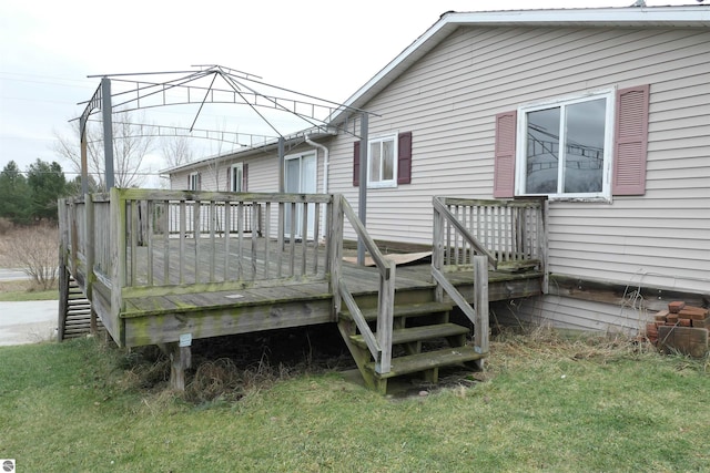 wooden terrace featuring a lawn