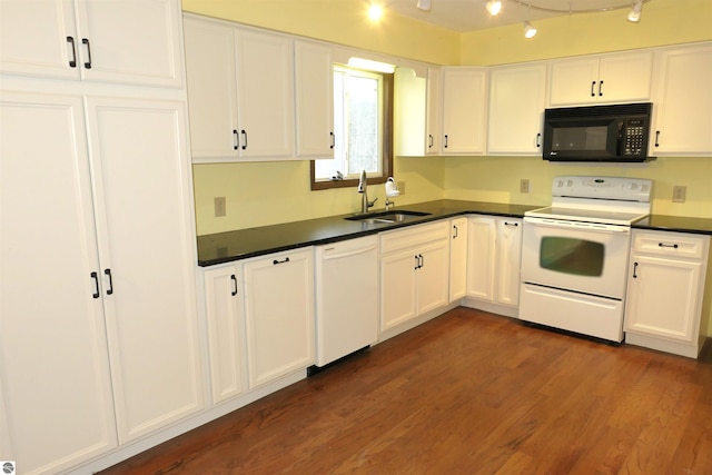 kitchen with white appliances, dark wood-type flooring, white cabinets, rail lighting, and sink