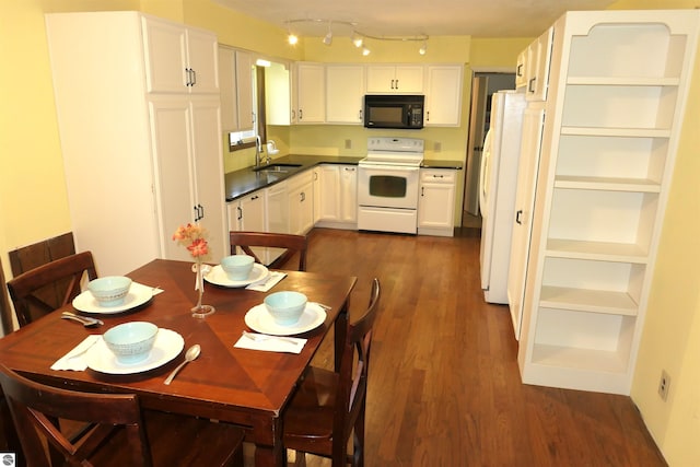 dining room featuring dark wood-type flooring and sink