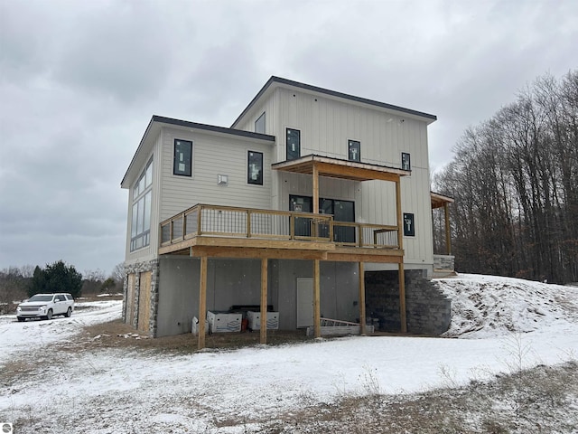 snow covered property with a deck