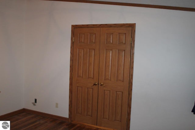 interior space with dark wood-type flooring and baseboards