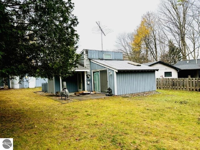 back of property featuring a lawn