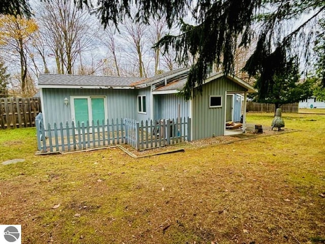 rear view of house with a lawn