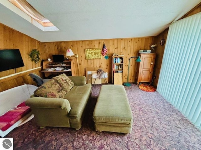 living room with carpet flooring, lofted ceiling with skylight, and wood walls