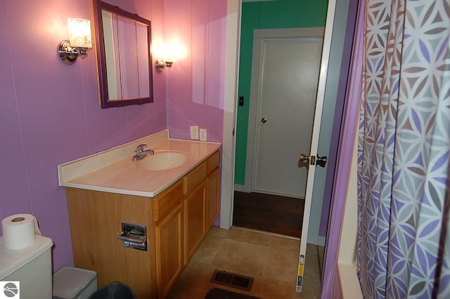 bathroom with tile patterned floors, vanity, and toilet