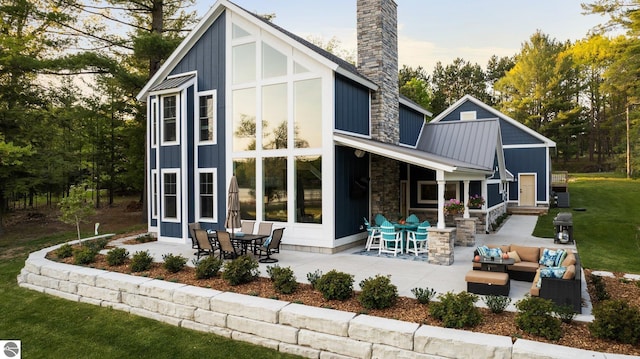 back of house featuring a patio area and an outdoor living space