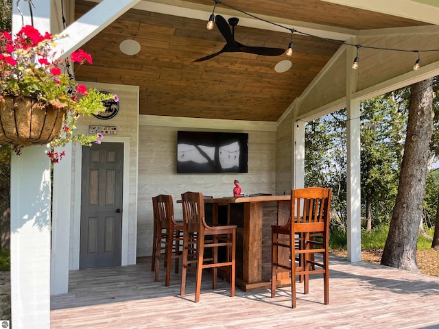 view of patio with ceiling fan and exterior bar