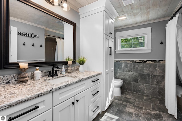 bathroom with wooden ceiling, crown molding, toilet, vanity, and tile walls