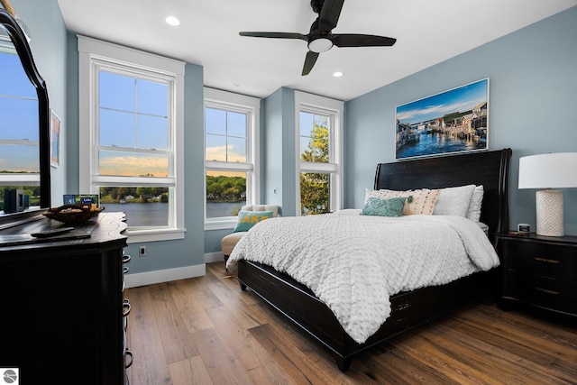 bedroom with ceiling fan and hardwood / wood-style flooring