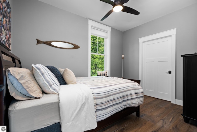 bedroom featuring ceiling fan and dark wood-type flooring