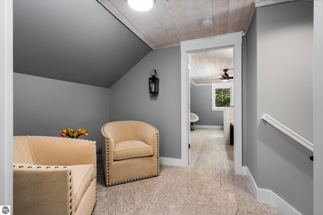 interior space with ceiling fan, light colored carpet, wooden ceiling, and vaulted ceiling