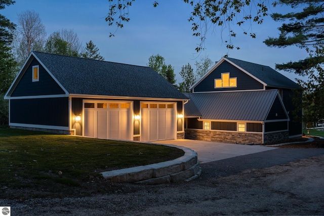 view of front of home featuring a yard, an outdoor structure, and a garage