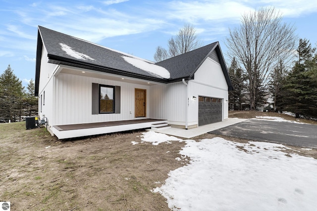 view of front of house with central AC and a garage