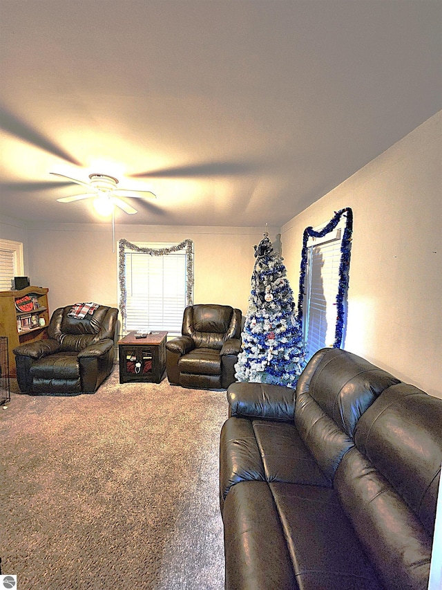 carpeted living room with ceiling fan