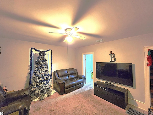 carpeted living room with ceiling fan